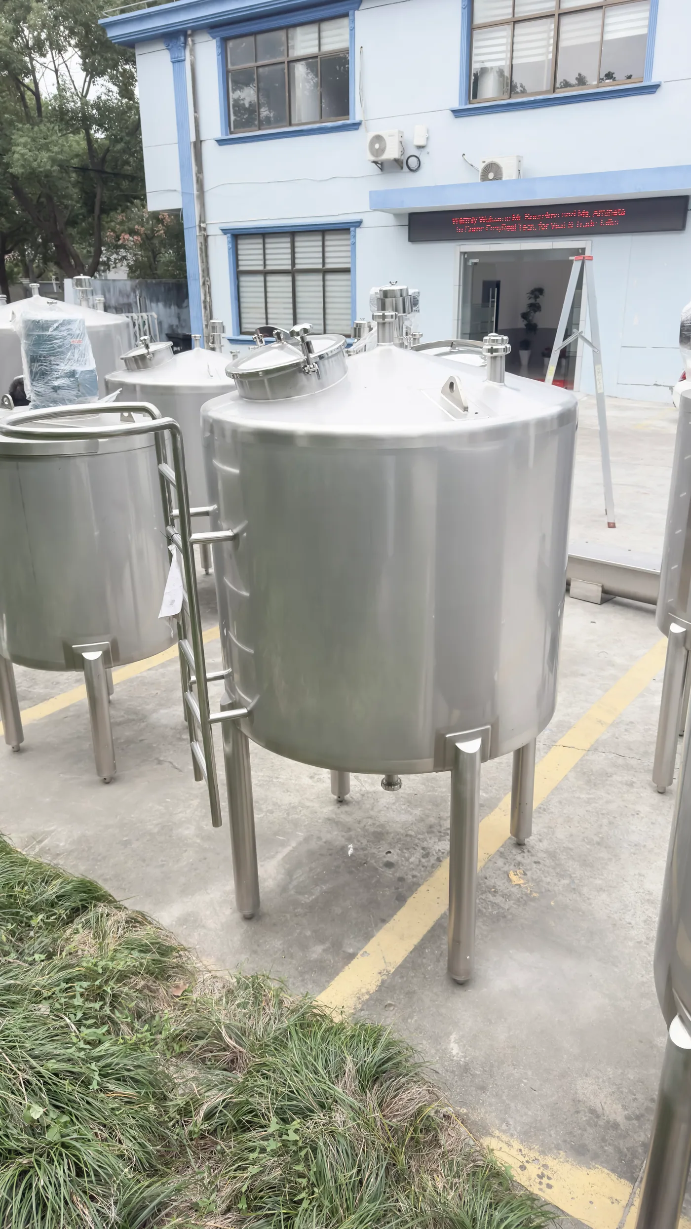 Stainless jacketed holding tank with agitator motor and service platform