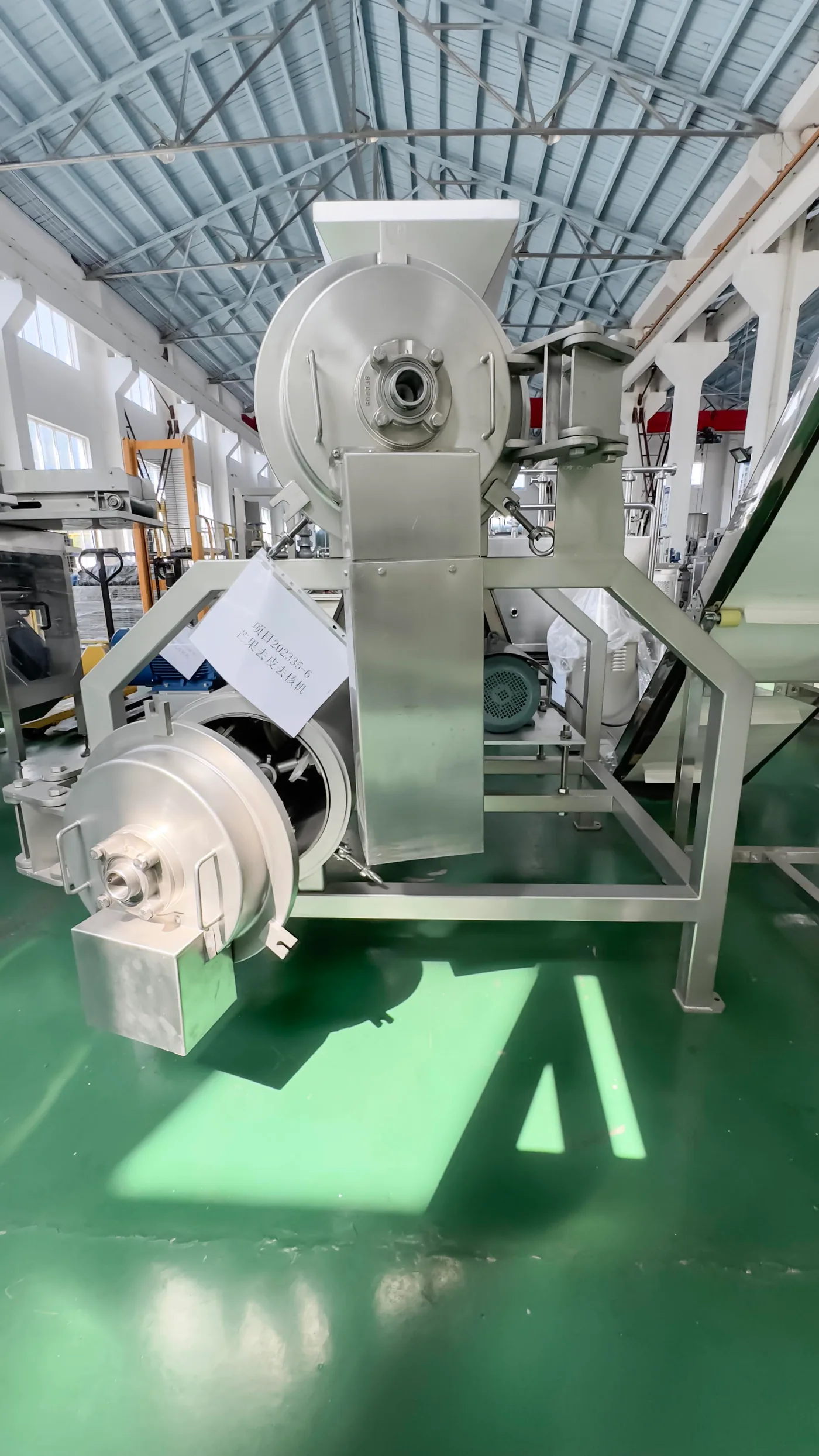 Side view of a fruit peeling and destoning machine